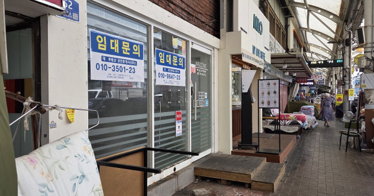 셔터를 내린 상가 점포에 임대문의 안내문이 붙어 있는 거리 풍경